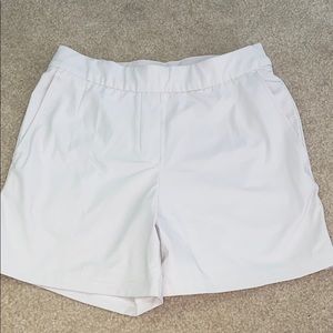 Light worn Nike cream colored dri fit shorts